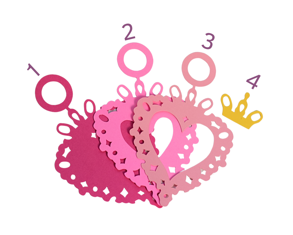 a pile of paper cut outs with numbers and crowns