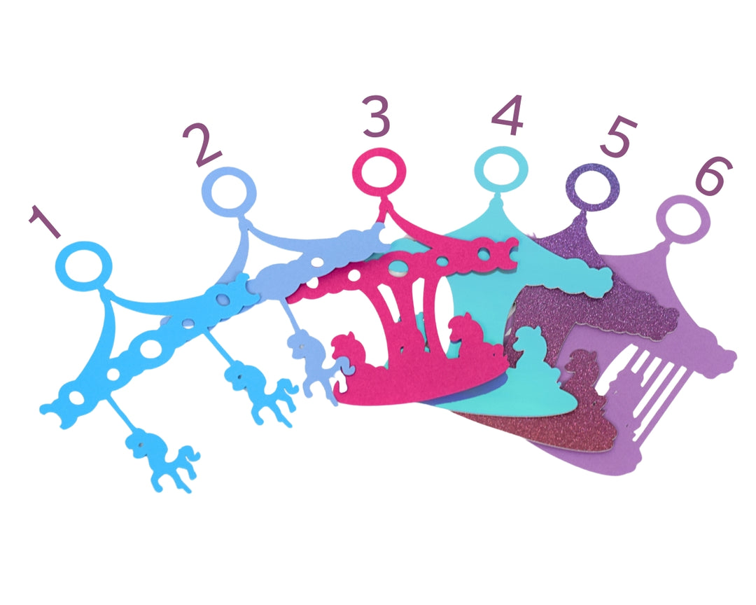 a group of different colored crowns sitting next to each other