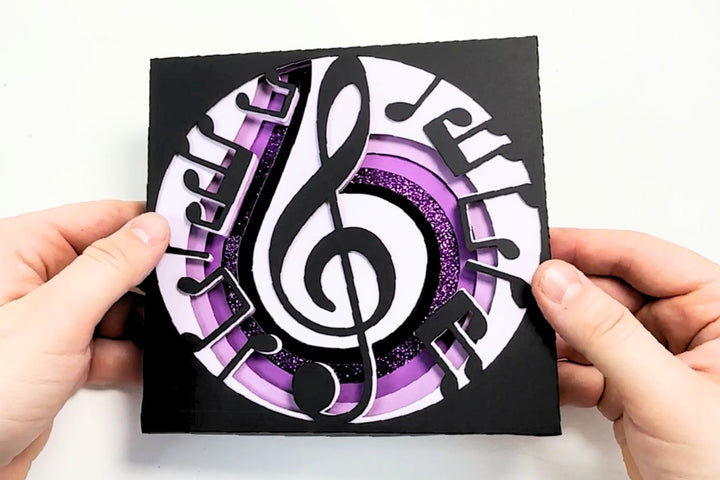 Elegant Music Notes Shadow Box featuring a treble clef and swirling musical notes, crafted from layered cardstock with a seamless, no-glue assembly.