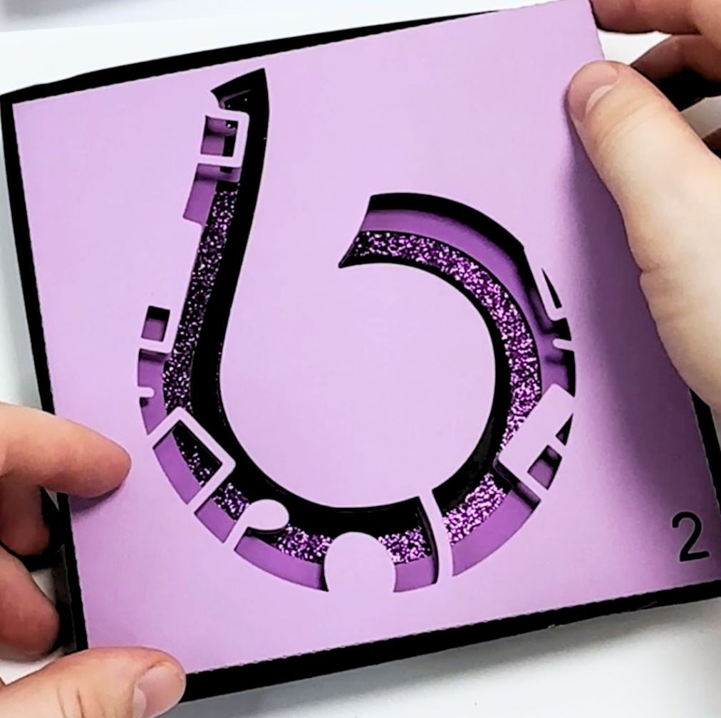 a person cutting out a number with scissors