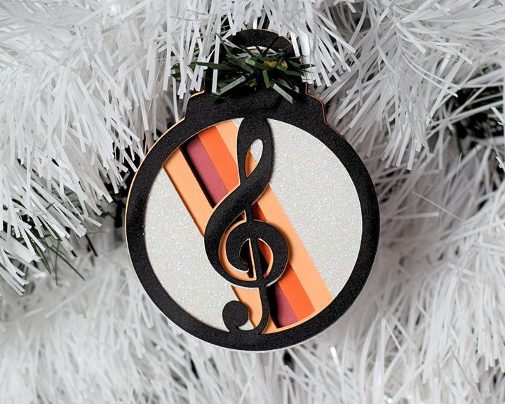 a christmas ornament hanging from a white christmas tree